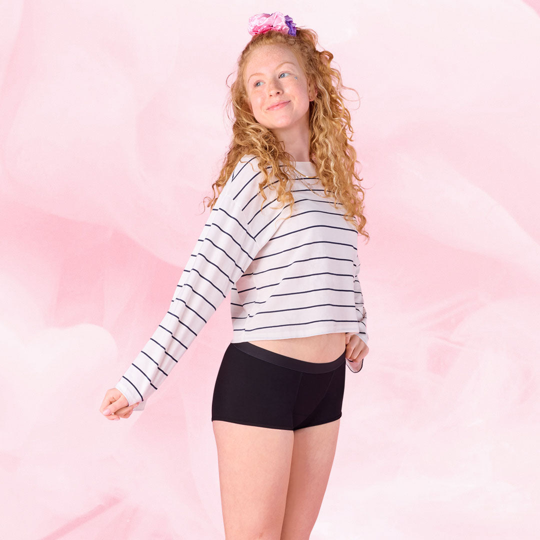 Person i sorte Teens Boxer for middels mens og stripete skjorte.