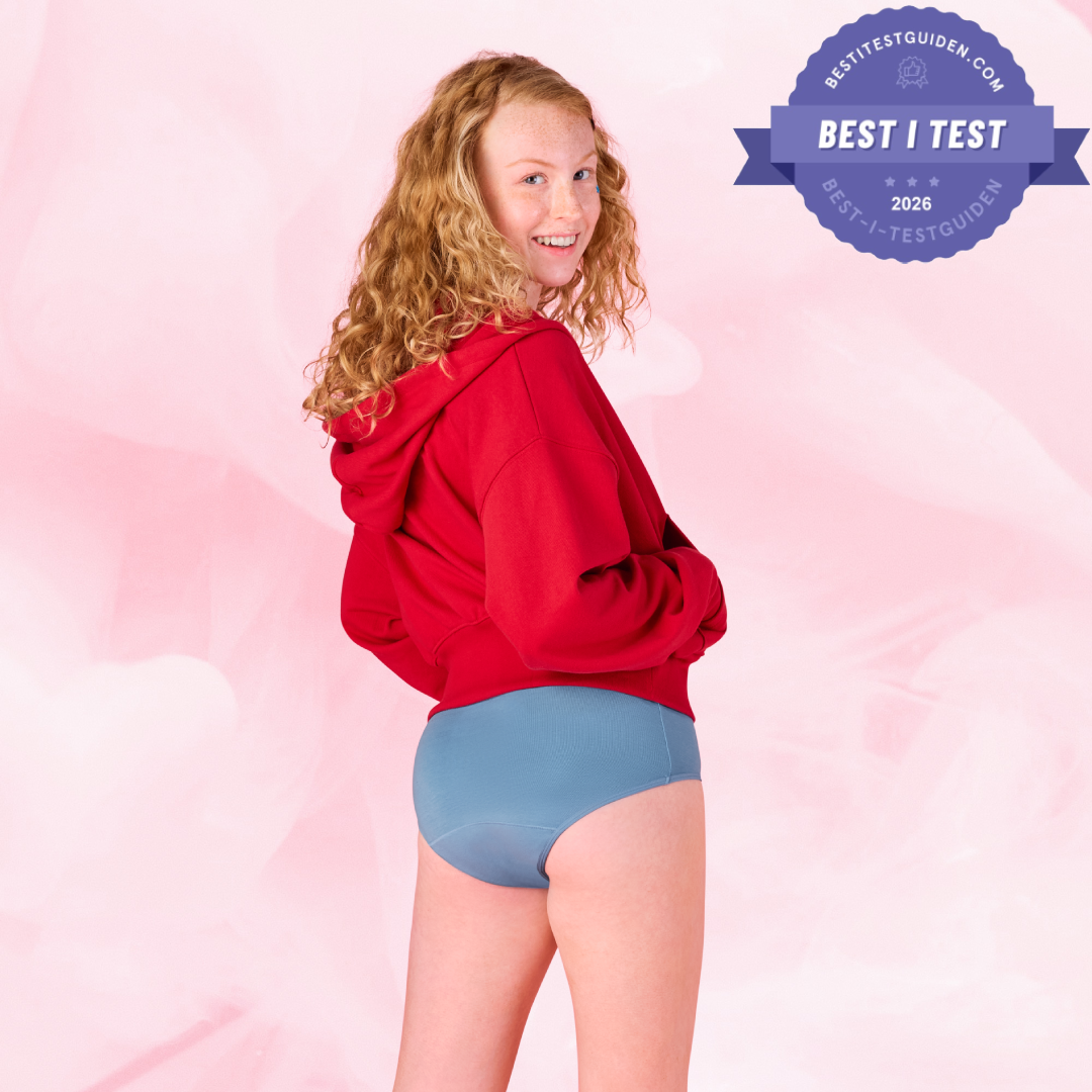 Person iført Teens Hipster for kraftig mens, smilende over skulderen.